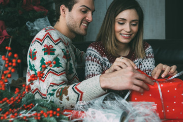 Wall Mural - Woman and man wrap Christmas present