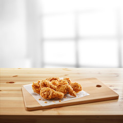 crispy coated batter southern style fried chicken in a wooden table