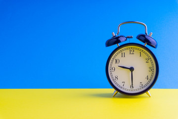 Clock on colorful background with selective focus and crop fragment. Copy space concept