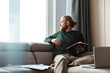 © Drobot Dean - Concentrated young bearded man sitting in home