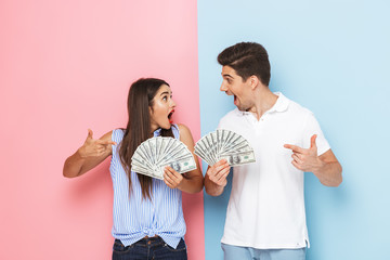 Canvas Print - Excited young couple standing isolated