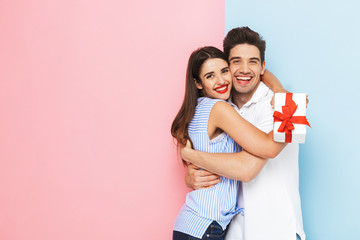 Wall Mural - Happy young couple standing isolated