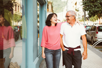 Wall Mural - Father and daughter having fun together walking on the street