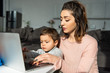 © LIGHTFIELD STUDIOS - cute little boy and his mother using laptop at table in living room at home