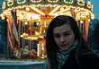 portrait of a girl in front of carousel