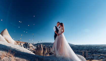 Wedding in Cappadocia G?reme with a young married couple on the background of balloons.