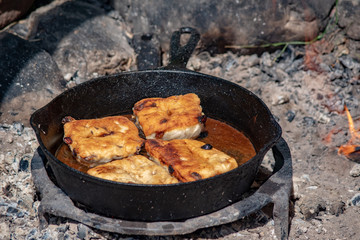 Bannock - fry bread in the pan on hot coals