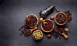 Coffee, anise, cardamon and nutmeg on black background.
