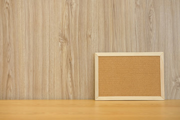 blank cork board on wooden desk. bulletin corkboard