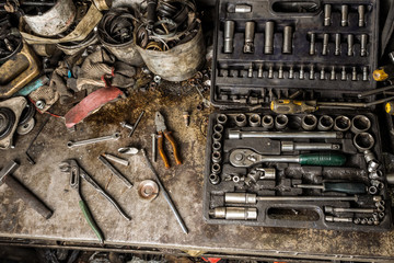 Wall Mural - A top view image of hand tools. Set of tools on concrete panel background with copy space. Many chrome vanadium wrench tools and nuts on black box. DIY.