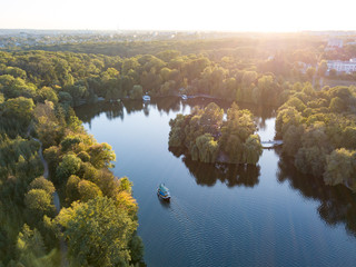 Poster - Beautiful countryside landscape picturesque river with ships, green forest with summer sky at sunset. Aerial view from drone at Sofiyivsky park, city Uman, Ukraine