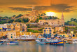 Beautiful cityscape over Gozo island, medieval architecture of castle and boats on the harbor of Malta