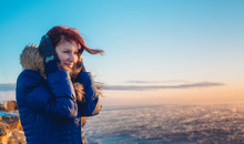 Young Beautiful Girl Woman Enjoying Sunset At Stormy Sea In Winter