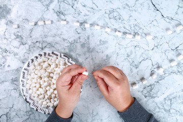 Wall Mural - Diy marshmallow garland. Guide on photo how to make a decorative marshmallow garland, threads, needles and branches with your own hands. Handmade Christmas decor. Top view. Step by step.