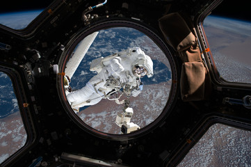 Wall Mural - astronaut spacewalk near the earth. view from the space ship illuminator. elements of this image fur