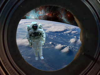 Wall Mural - astronaut spacewalk near the earth. view from the space ship illuminator. elements of this image fur