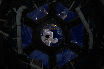 Wall Mural - astronaut spacewalk near the earth. view from the space ship illuminator. elements of this image fur