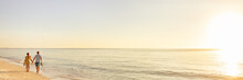 Beach Couple Walking On Beach Watching Sunset Tropical Landscape Banner Panoramic Background. Summer Holidays Destination Panorama. Relaxing Vacation - Travel Tourists.