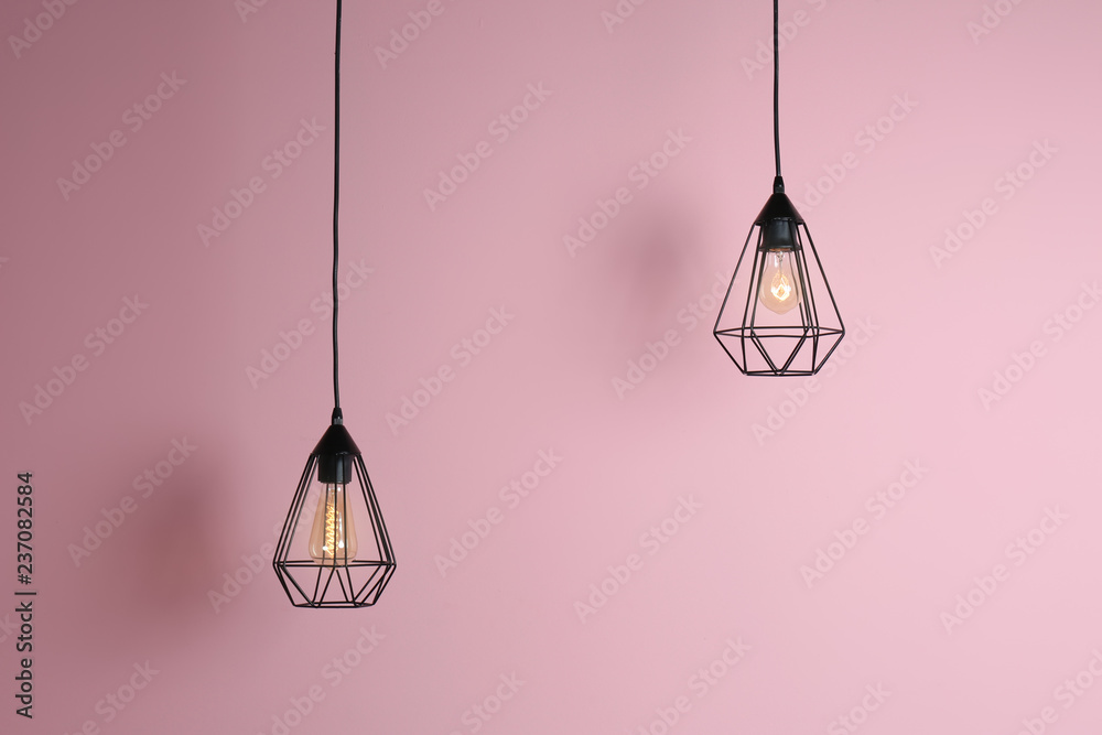 Modern hanging lamp on color background. Idea for interior design - obrazy, fototapety, plakaty 