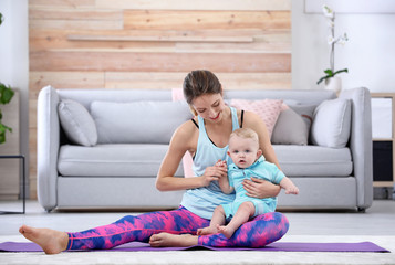 Sticker - Young sportive woman doing exercise with her son at home. Fitness training