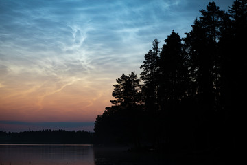 Wall Mural - night shining clouds over lake in finland