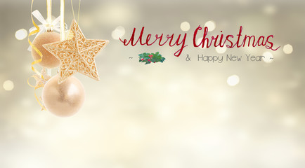 Hanging golden christmas balls with garlands on silver bokeh background with Merry Christmas greetings