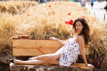 Young beautiful brunette woman in white dress