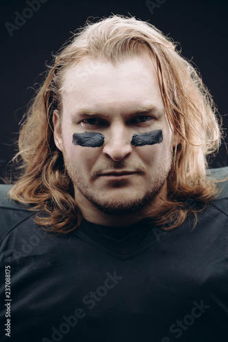 Face And Shoulder Portrait Of Confident American Football A