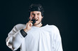 © alfa27 - Caucasian Hockey player tastes the puck, having fun, demonstrates the way he lost the tooth, looking at camera isolated on black background.