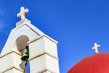 Two Crosses In Perspective With Bell Tower And A Re Dome In Mykonos, Greece.