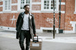 © Rawpixel.com - Handsome tourist walking with a suitcase