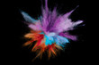 Colored powder explosion. Abstract closeup dust on backdrop. Colorful explode. Paint holi