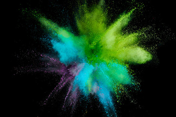 Wall Mural - Colored powder explosion. Abstract closeup dust on backdrop. Colorful explode. Paint holi