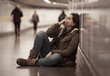 © SB Arts Media - Young depressed woman crying on the ground on subway underground