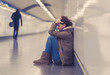 © SB Arts Media - Young depressed woman crying on the ground on subway underground