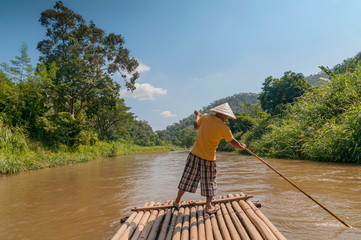  Bamboo rafting in tropical forest near Chiang Mai, Thailand.