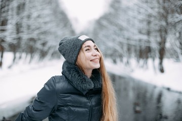 Wall Mural - girl blonde in a snowy forest in winter clothes.