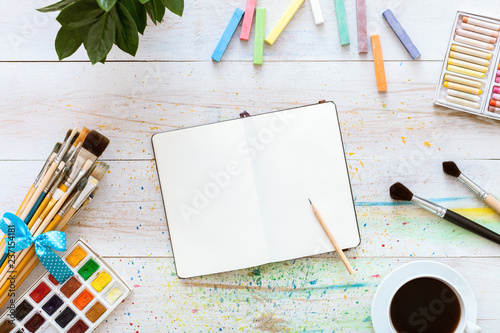 Fotografie, Obraz Colorful creative table with blank notebook for sketches and paints, pencil, pai