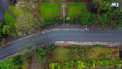 Aerial view of a school keep clear road sign in the UK