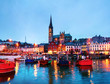 Port, houses, restaurants, shops, bars, pubs and Cathedral at night in Cobh, Ireland