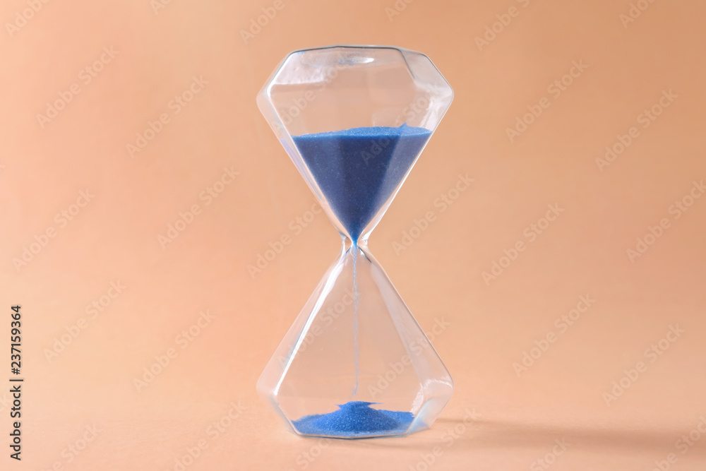 Hourglass on color background. Time management concept