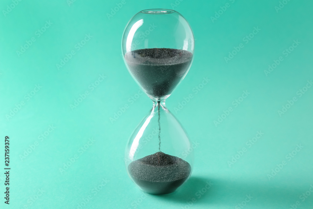Hourglass on color background. Time management concept