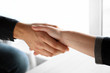 © Pixel-Shot - People shaking hands indoors