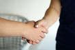 © Pixel-Shot - People shaking hands indoors