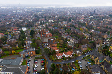 Aerial view over suburban homes and roads in Birkenhead, UK