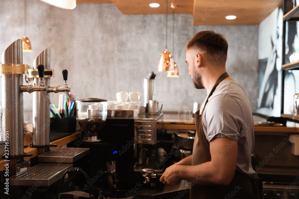 Barista preparing fresh aromatic coffee in cafe