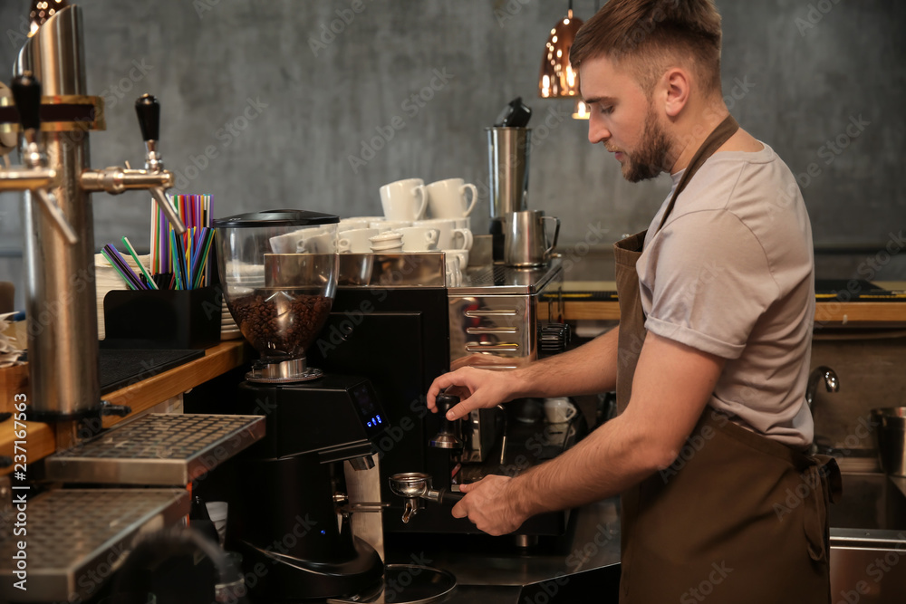 Barista preparing fresh aromatic coffee in cafe