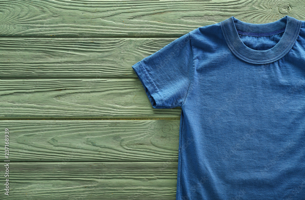 Blank blue t-shirt on wooden background