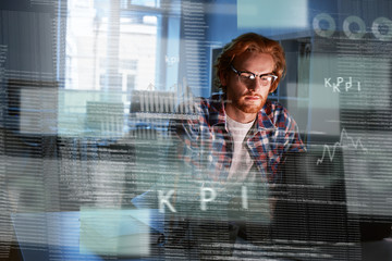 Young concentrated computer developer writing new code