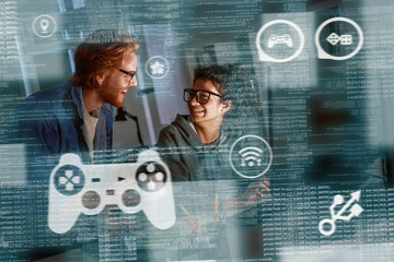 young indian woman game developer and red haired man are laughting about idea